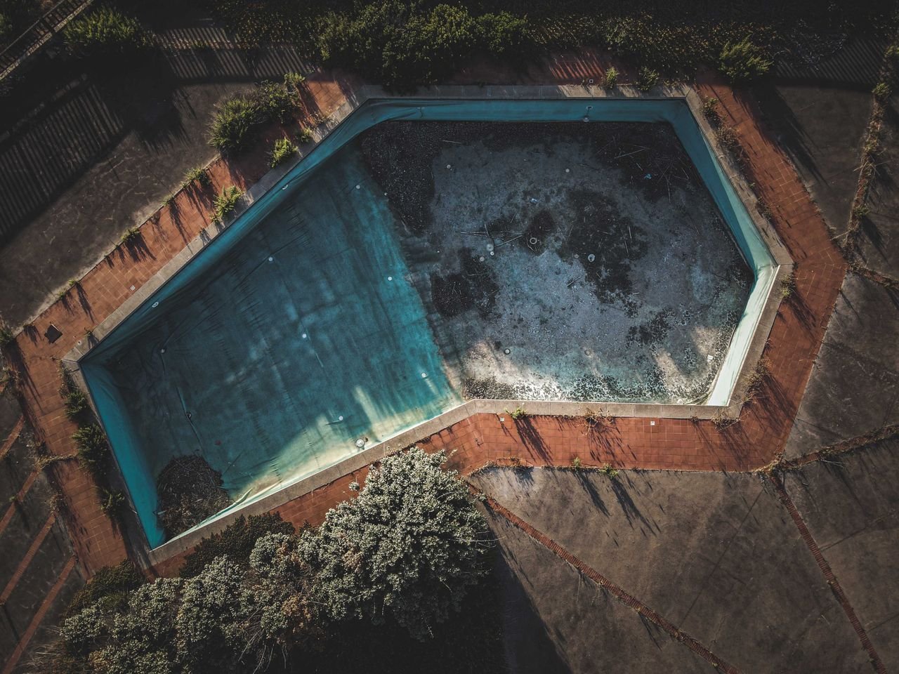 Technician testing water quality and adjusting chemical balance during pool maintenance service