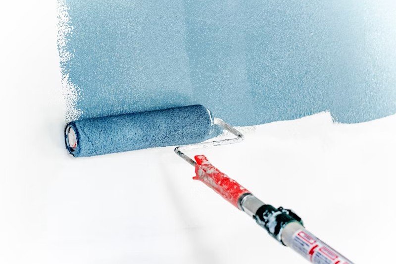 Expert painters working on residential wall preparation, priming, and high-quality paint finishing.