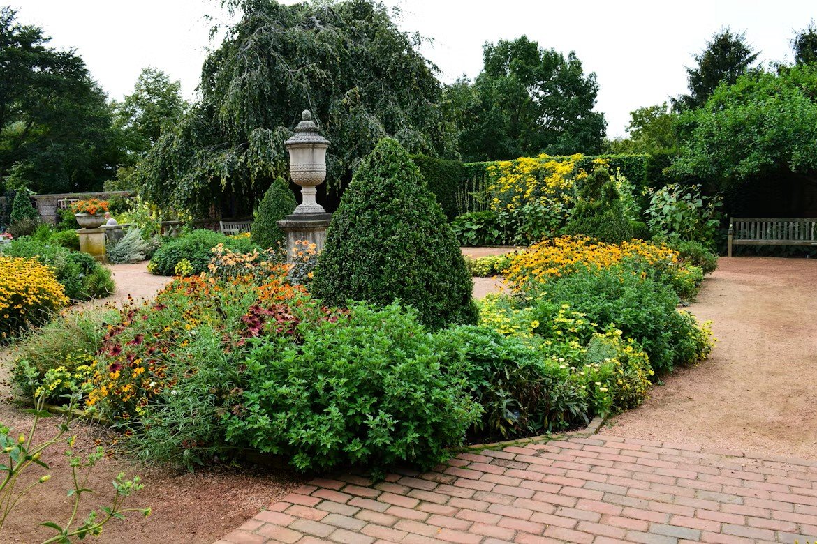 Expert gardeners installing colorful plants, shrubs, and maintaining healthy lawns.