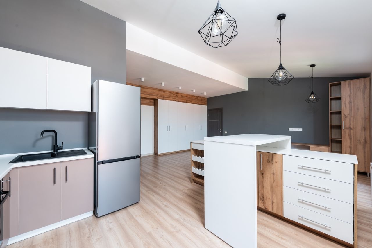 Modern home renovation featuring updated kitchen cabinets, marble countertops, and warm ambient lighting