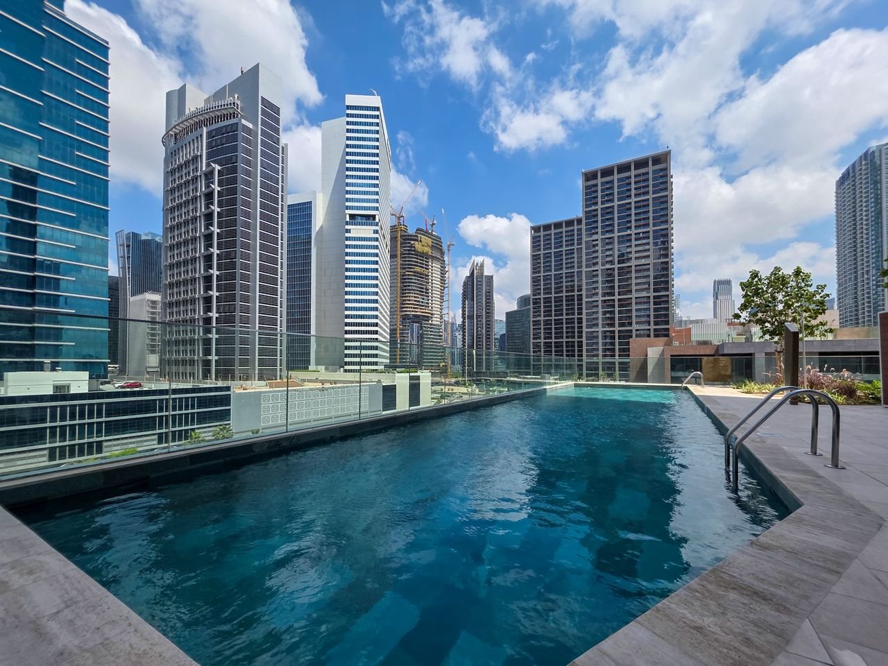 Professional swimming pool construction service showing a modern custom backyard pool design.