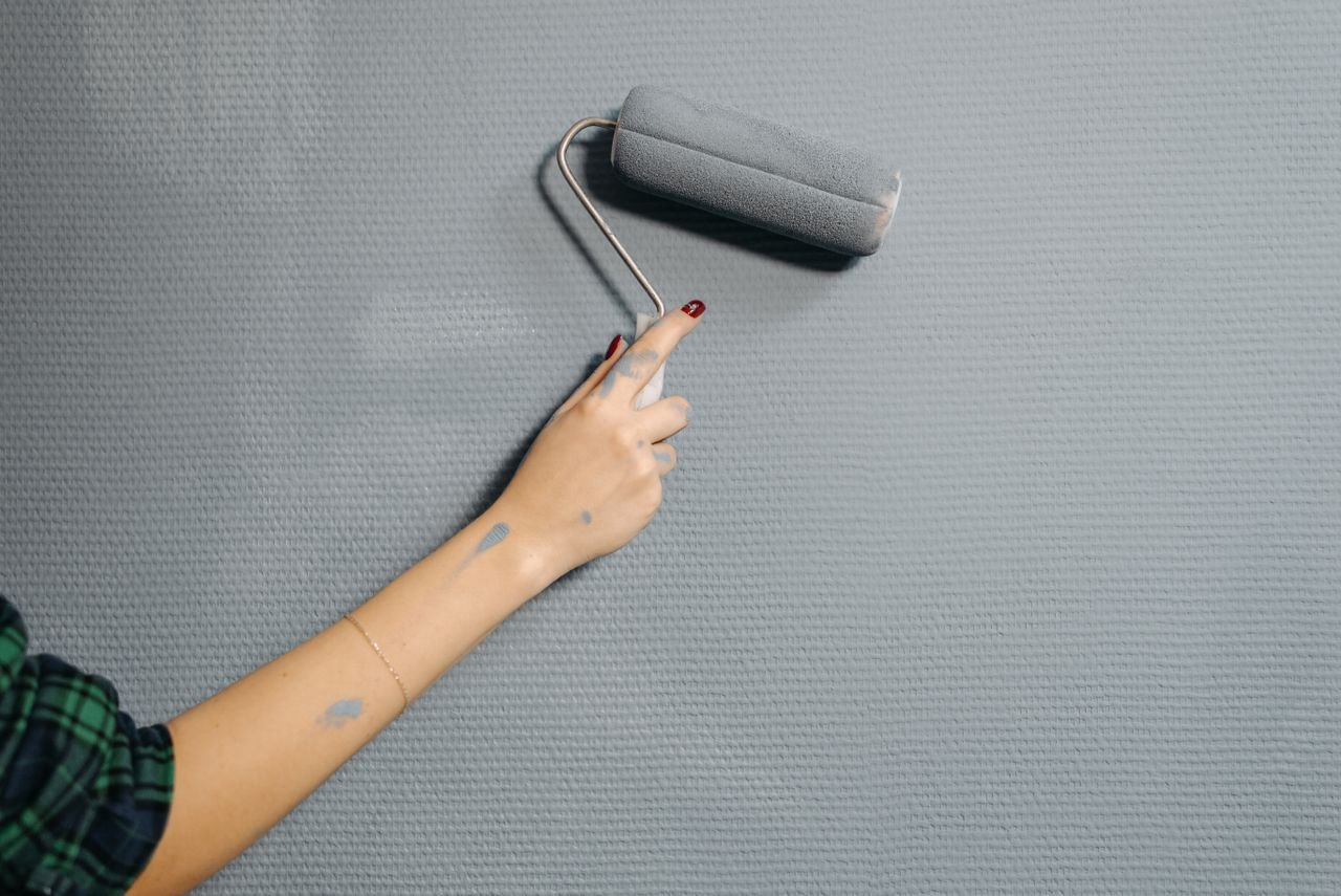 Expert painters working on residential wall preparation, priming, and high-quality paint finishing.
